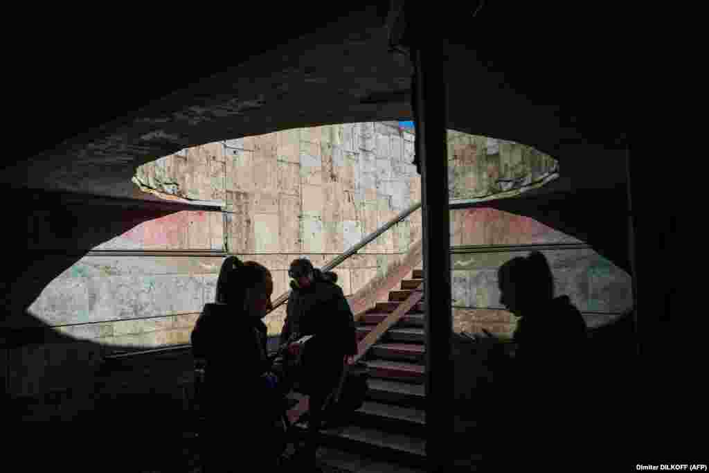 Women walk in an underpass in central Kyiv.