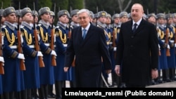 Kazakhstan's Qasym-Zhomart Toqaev (left) is welcomed to Baku by Azerbaijani President Ilham Aliyev on March 11.