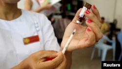 A nurse prepares a measles-rubella vaccine. Romania has seen a continuous decrease in the number of children vaccinated against measles prompted by anti-vaccination campaigns on social media. 