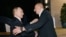 Azerbaijani President Ilham Aliyev (right) greets his Russian counterpart in Baku on August 17.