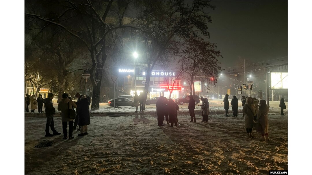 People gather in the street after the earthquake in Almaty on January 22.