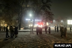People gather in the street after the earthquake in Almaty on January 22.