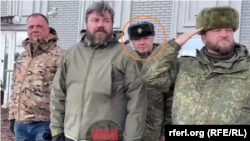 Lieutenant General Vladimir Alekseyev, deputy head of the GRU (circled), standing next to Russian lawmaker Aleksandr Borodai (far left), a former leader of separatists in eastern Ukraine, and Kremlin-connected tycoon Konstantin Malofeyev (second from left) at the February 2023 gathering of the group known as the Union of Donbas Volunteers. The image is from a video published by the Kremlin-loyal Telegram channel WarGonzo.