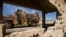 An army vehicle drives past the ruins of a building during a Turkish and Russian military patrol in the countryside of Rumaylan in Syria's northeastern Hasakeh Province bordering Turkey, on April 27.