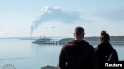 A view across the Kerch Strait shows a fuel depot on fire near the Crimean bridge in the Russian village of Volna on May 3.