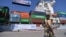 A Pakistani soldier stands guard beside a ship carrying containers during the opening of a trade project in Gwadar Port in 2016. 
