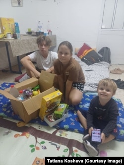 After evacuating Ashkelon, Tetyana Kosheva's three children now live with her in a vacant apartment near Tel Aviv. “I was sitting in a basement in my city,” she said of Kharkiv. “I was looking for a car, for volunteers [to help], I was leaving. And, again, it was the same thing. Again, the children. Again, [getting] those bags in 30 minutes. Everything repeated itself.”