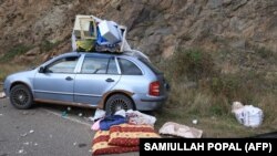 An abandoned car left by fleeing Armenians is seen on the side of a road leading to the Lachin corridor during an Azeri government organized media trip to Nagorno-Karabakh, October 3, 2023.