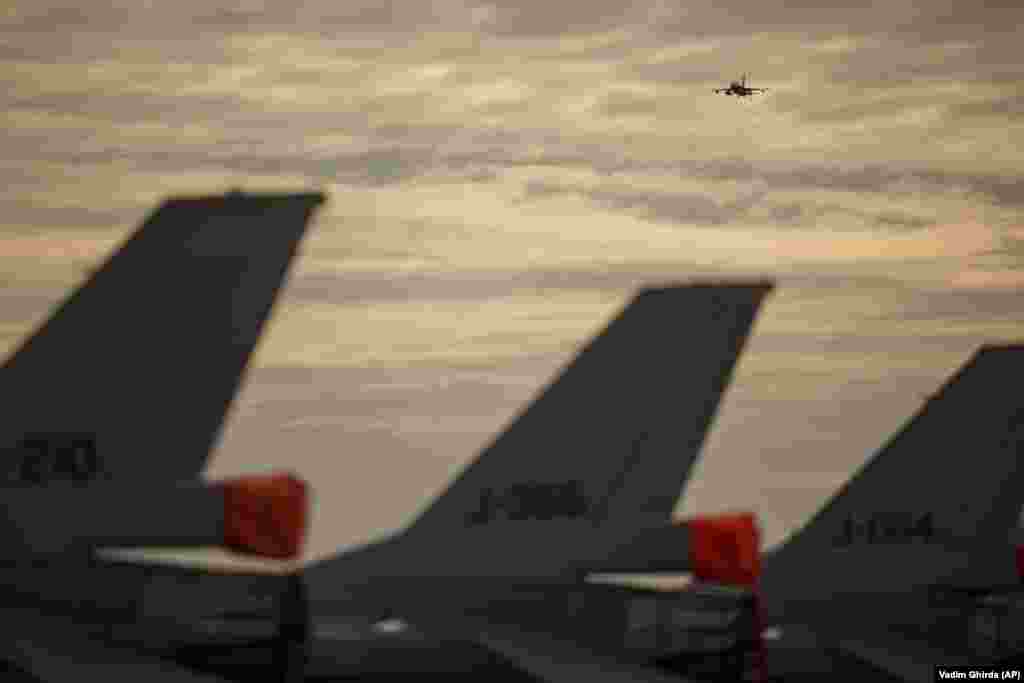 A Romanian Air Force F-16 fighter plane flies above the air base. Romania, which has been a NATO member since 2004, has ramped up its defense spending while NATO has bolstered its presence on Europe&#39;s eastern flank by sending additional multinational battle groups to alliance members Romania, Hungary, Bulgaria, and Slovakia. &nbsp;