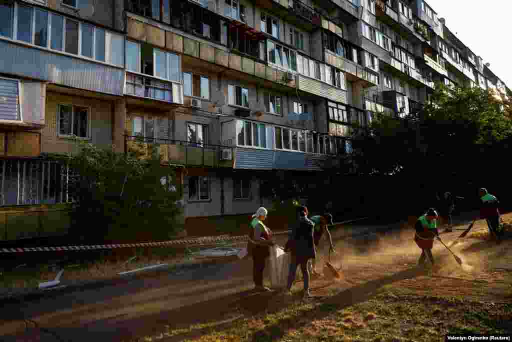 Municipal workers clear away the debris at the site of the residential building damaged during the early morning attack. Russia has intensified missile and drone attacks on the Ukrainian capital as&nbsp;Kyiv&nbsp;prepares to launch a counteroffensive. Russia says Ukrainian shelling of border areas has increased in recent weeks as&nbsp;Kyiv&nbsp;prepares its counterattack