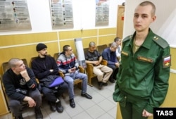 Conscripts wait at a St. Petersburg army recruitment office before departing for military service with the Russian armed forces on October 17.