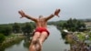 A competitor jumps from a 22-meter-high bridge during an annual high-diving competition near the town of Gjakova in Kosovo.&nbsp;