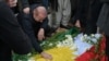 People mourn over the graves of Iraqi businessman Peshraw Dizayee and his daughter Zhina on January 16.