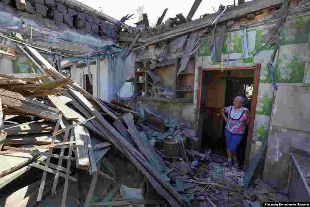  Local resident Natalya stands amid the debris of her house hit by shelling, which local Russian-installed authorities called a Ukrainian military strike, in Makyivka in Ukraine&#39;s Donetsk region. &nbsp; 