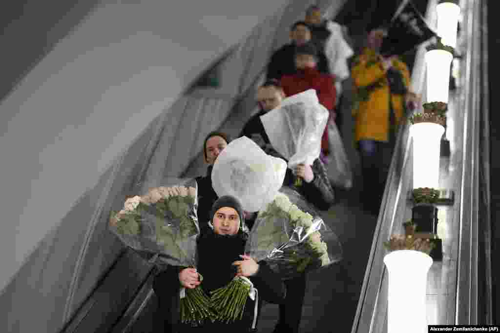 Many men in Russia were seen carrying flowers such as these in a Moscow subway.&nbsp;According to tradition, men give flowers and gifts to female relatives, friends, and colleagues, even though in the past two years flowers have gotten more expensive.