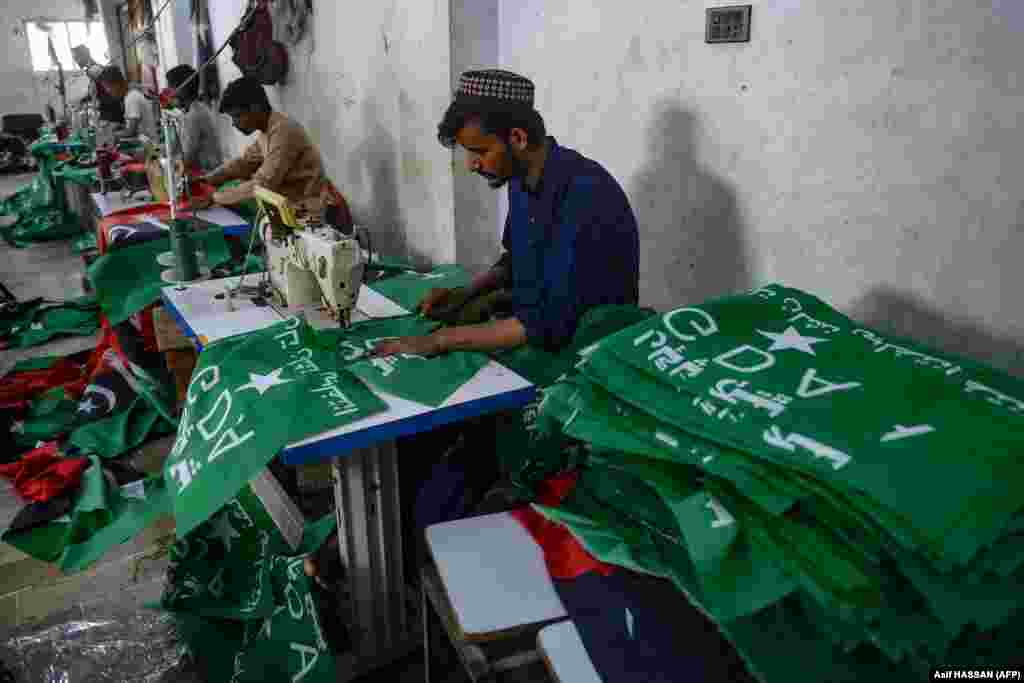 Workers in Karachi stitch the flags of the Grand Democratic Alliance (GDA) -- a white star -- and the Pakistan People&#39;s Party (PPP) -- a sword at a factory. Nearly 23,000 candidates contesting for national and provincial assemblies have had their nomination papers accepted.