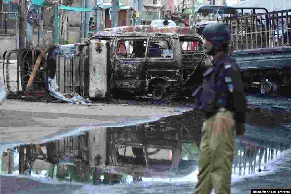 Pakistani security officials patrol the scene of deadly clashes between two armed groups in Karachi.&nbsp;