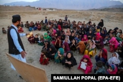 Wazir Khan, an Afghan man, conducts classes at a mobile school that he voluntarily runs, on the outskirts of Kabul in October.