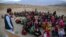 Wazir Khan, a 23-year-old Afghan, conducts outdoor classes on the outskirts of Kabul on October 4. Khan started the Today's Child Mobile School more than a year ago to provide free education for needy Afghan families.