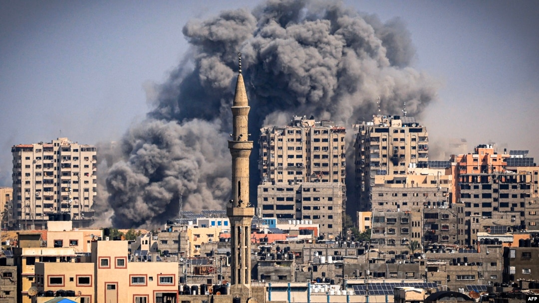 Smoke plumes billow during Israeli air strikes in Gaza City on October 12.