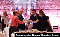 Orban and Gharibashvili, along with their wives, make a toast in Tsinandali, Georgia, on October 10.