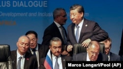 Chinese President Xi Jinping (above right) walks past Russian Foreign Minister Sergei Lavrov and Chinese Foreign Minister Wang Yi during a BRICS summit in Johannesburg in August 2023.