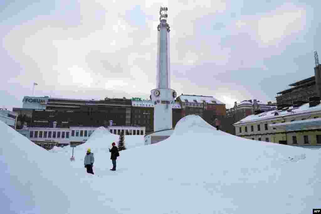 Njerëzit qëndrojnë në një zonë të mbuluar me borë në kryeqytetin finlandez, Helsinki, më 3 janar 2024, ndërsa acari goditi vendin. Temperaturat në Helsinki pritet të arrijnë deri në -20°C në ditët në vijim.