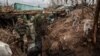 UKRAINE -- Call-sign Jimmy, commander of a unit of the 24-th Mechanized Brigade and Chorna(Black), a service dog moves through a trench in the Donetsk region,