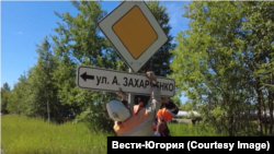 Рабочие устанавливают дорожный указатель на улицу Захарченко. Июль 2022 года