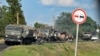 Russian military trucks damaged by Ukrainian shelling line a road in the Kursk region on August 9. 