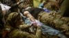 Once the wounded are pulled out of battle, often after too many hours waiting for help, they're brought to a stabilization point where doctors and paramedics try to keep them alive long enough to make it to the hospital.