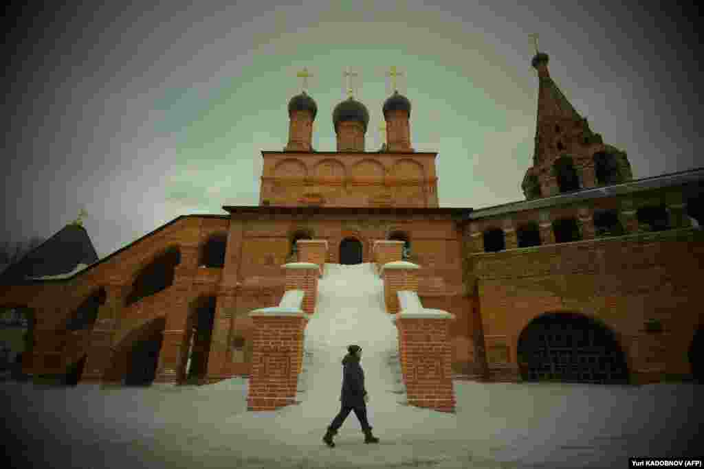 A pedestrian walks past the Krutitskoye podvorye ecclesiastical residence in central Moscow.