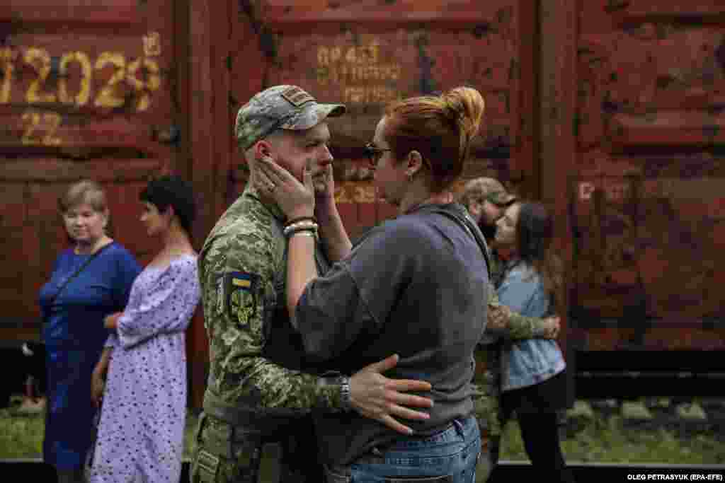 A couple says their goodbyes. R&amp;R is used to rejuvenate and boost the morale of servicemen before they return to active duty.