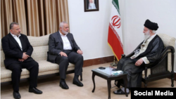 Hamas's Ismail Haniyeh (center) and Iranian Supreme Leader Ayatollah Ali Khamenei (right) met in Tehran.