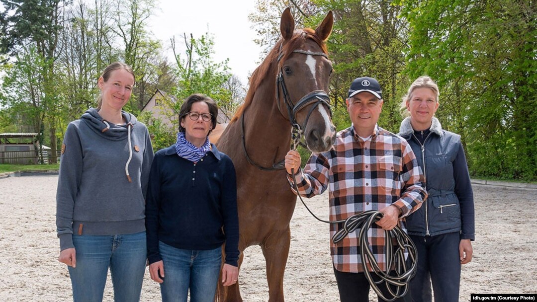 Turkmenistan's former president, Gurbanguly Berdymukhammedov (second from right), is seen visiting a horse center in Germany.