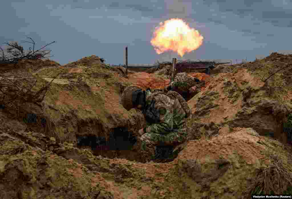 Ukrainian soldiers fire a mortar during an exercise in the Kyiv region.