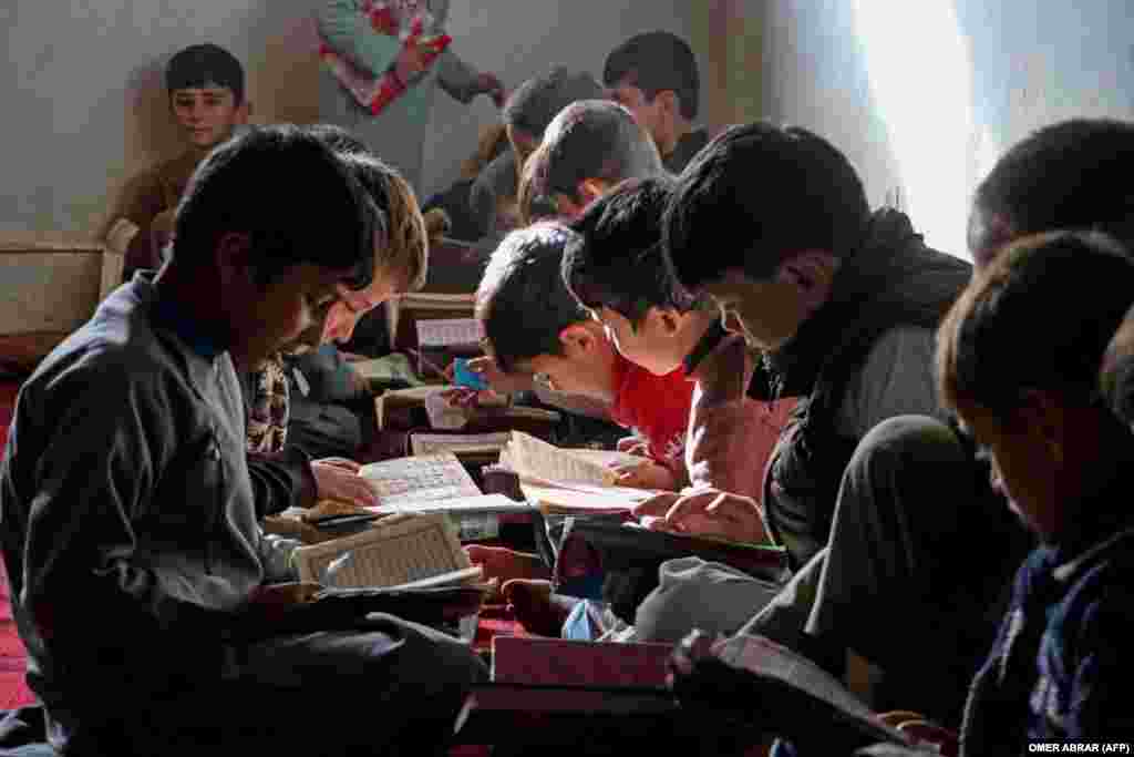 Afghan children read the Koran at a madrasah or Islamic school in the Fayzabad district of Badakhshan Province.