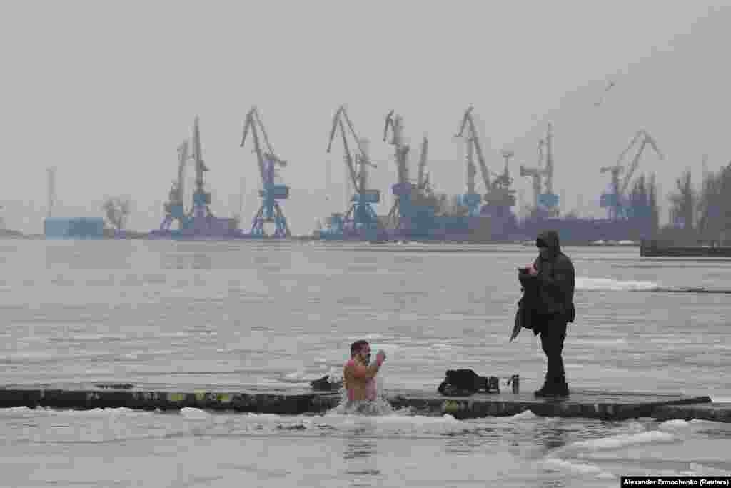 While many believers participated in large celebrations, some were more subdued, such as this man taking a dip in the icy waters of the Azov Sea in Russian-occupied Mariupol, Ukraine.