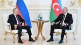 Russian President Vladimir Putin speaks with Azerbaijani President Ilham Aliyev Aliyev on June 18.