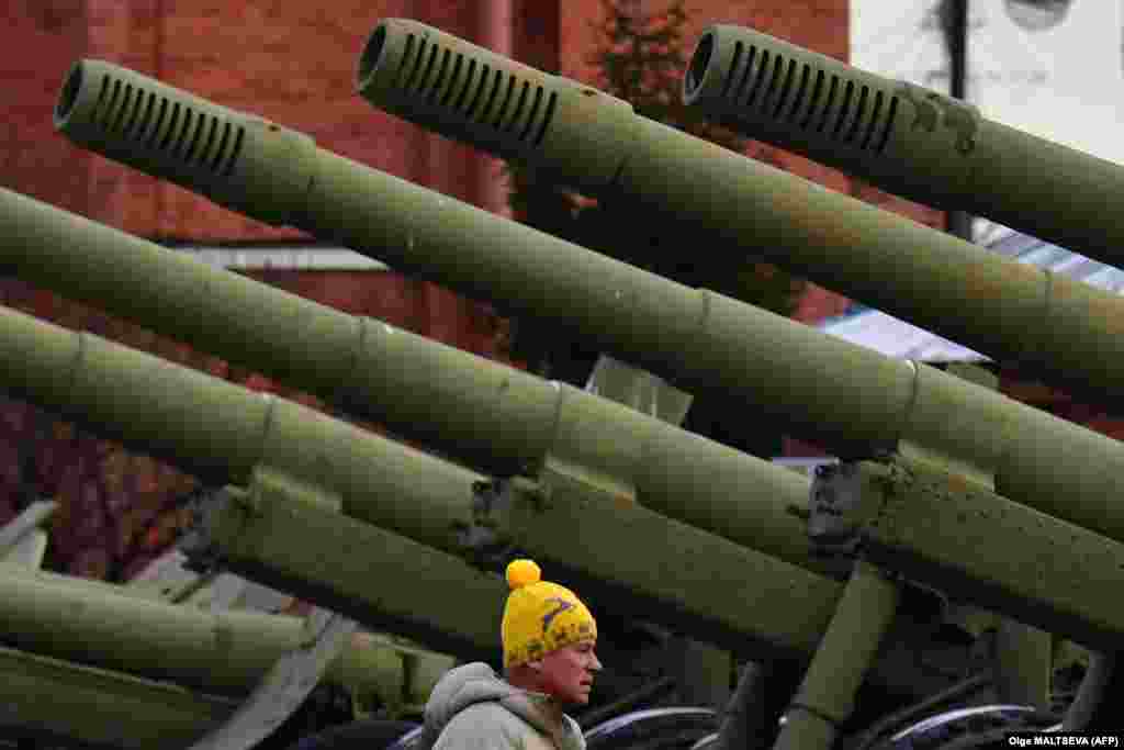 A man walks by artillery gun barrels as he visits an exhibition of military equipment and weapons at the Military Historical Museum of Artillery, Engineering, and Communications Forces in St. Petersburg on November 19, which Russia celebrates as the Day of Missile Forces and Artillery.