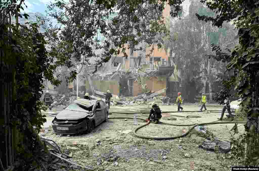 Rescuers work at the site of a Russian missile strike in Kharkiv on August 6.