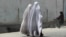 Burqa-clad Afghan women walk on a road in Kandahar. (file photo)