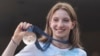 Romanian gymnast Ana Maria Barbosu poses with her Olympic bronze medal in Bucharest on August 16.