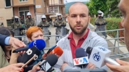 Mladen Perovic was singled out after the head of Kosovo's national journalists' association praised him on Twitter for helping reporters who were stuck in the cafe as mayhem reigned outside. 