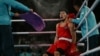 A Kazakh boxer catches his breath between rounds at a match during the Paris Olympics.