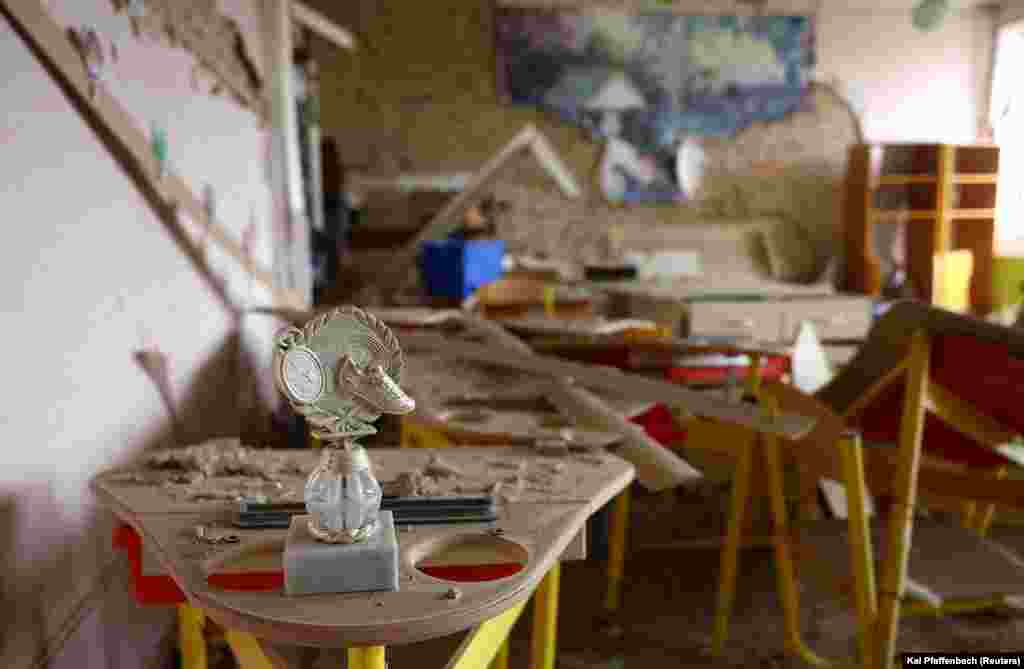 A sports trophy sits in a destroyed classroom in Chasiv Yar. Yevgeny Prigozhin, founder of Russia&#39;s Wagner mercenary group, claimed on April 11 that his men had seized more than 80 percent of Bakhmut.