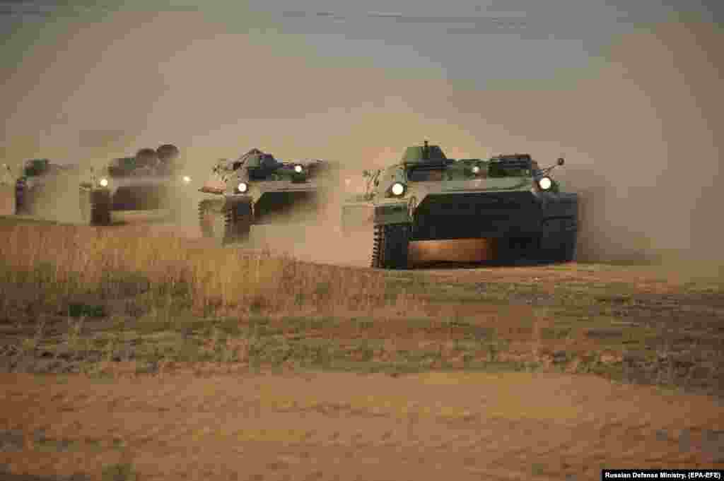 Armored vehicles grind through a Kazakh desert on September 16. The war games will involve troops from Russia, China, India, and Pakistan, along with the Central Asian states of Kazakhstan, Uzbekistan, Kyrgyzstan, and Tajikistan.