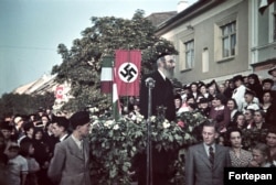 Un rabin vorbește în fața unei svastici în orașul Bistrița, în timp sosirii trupelor maghiare (1940).