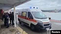 Врятованих членів екіпажу судна, пошкодженого внаслідок атаки безпілотника, вивозять машиною швидкої допомоги у Варні (Болгарія), 13 жовтня 2026 року