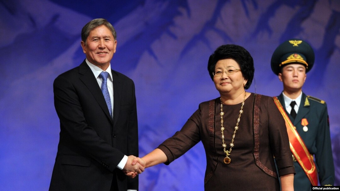 Almazbek Atambaev is congratulated by outgoing President Roza Otunbaeva at the inauguration on December 1.